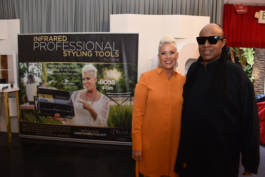 LOS ANGELES, CA - FEBRUARY 14: .Tools by Gina founder Gina Rivera (L) and Musician Stevie Wonder attend the GRAMMY Gift Lounge during The 58th GRAMMY Awards at Staples Center on February 14, 2016 in Los Angeles, California. (Photo by Vivien Killilea/WireImage)